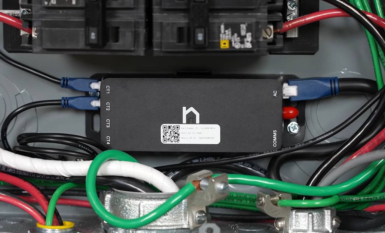Tesla Neurio energy meter mounted inside an electrical panel, showing CT1 through CT4 ports for current transformer connections